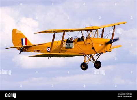 De Havilland DH.82A Tiger Moth aircraft in RAF trainer colours makes a flypast at Duxford Flying ...