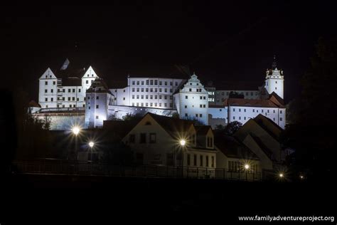 a large white castle lit up at night