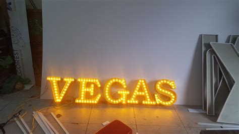 a neon sign that says vegas on it