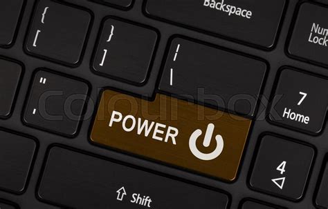 Close-up of a brown power button on a ... | Stock image | Colourbox