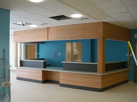 Local hospital A&E reception desk in beech veneer with bulkhead ...