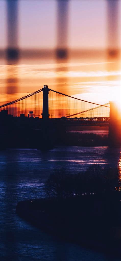 silhouette of Brooklyn and Manhattan Bridges durin... iPhone X Wallpapers Free Download