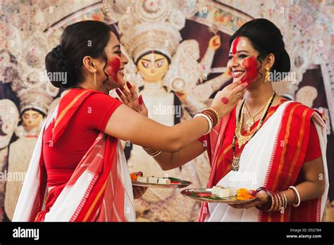 Bengali women celebrating Durga Puja Stock Photo - Alamy