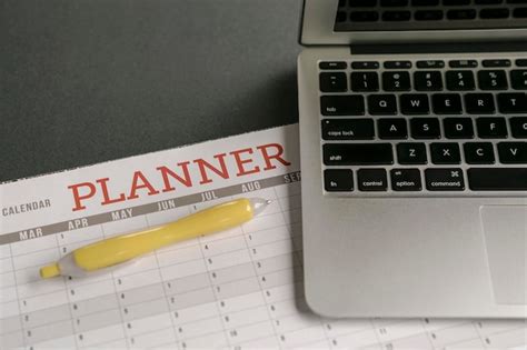 Premium Photo | Calendar planner with computer laptop on table