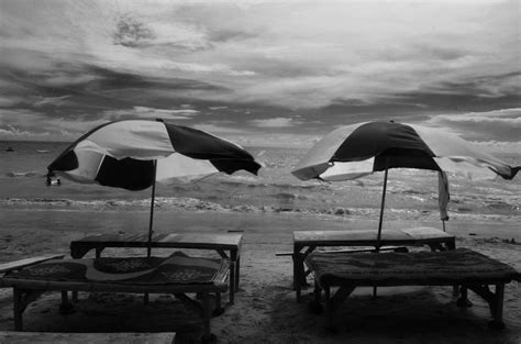 Grayscale Photography of Two Picnic Tables on Seashore · Free Stock Photo