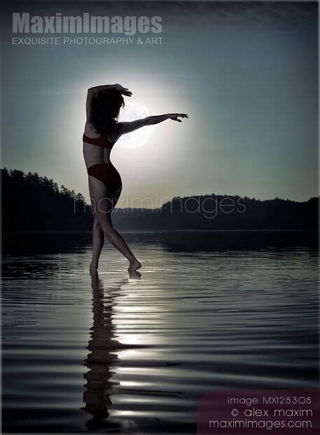 Photo of Woman dancing in moonlight under full moon on the water ...