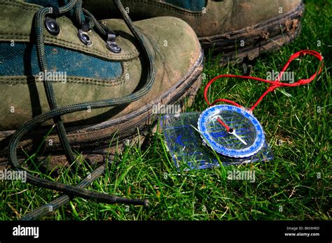 A walking boots and a compass Stock Photo - Alamy