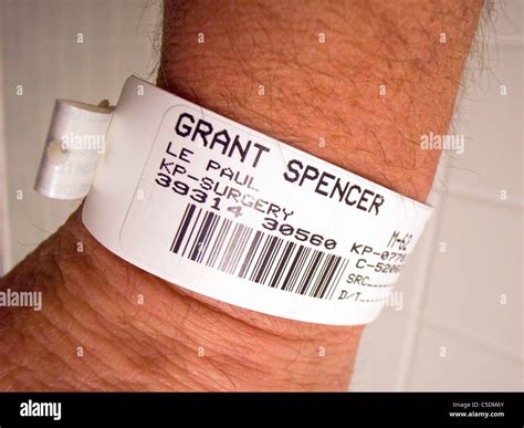 A hospital patient wears an identification wristband complete with ...