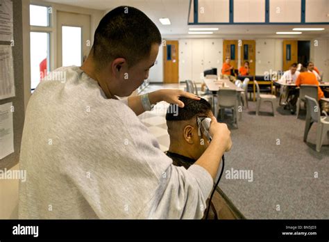 A Hispanic inmate gets a haircut in the dayroom of a cell block at the Santa Ana, CA, city jail ...