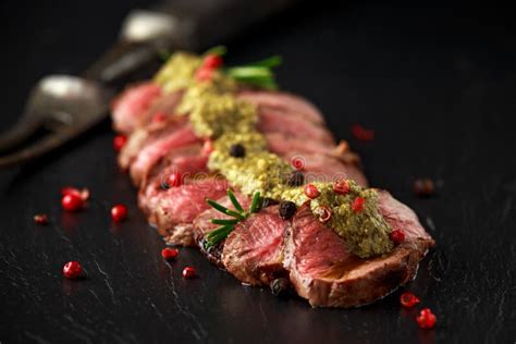 Medium Rare Venison Steak with Green Pesto Sauce and Pepper Stock Image ...