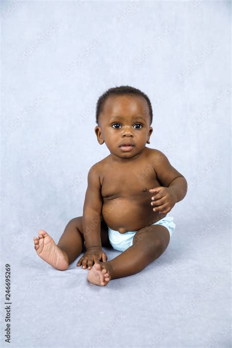 Sitting Up Adorable African American Baby Boy on a Grey Background ...