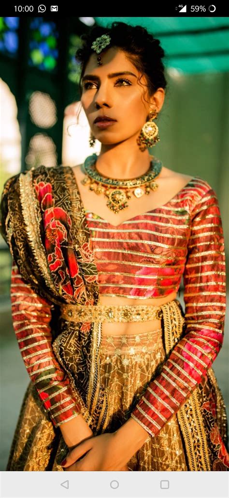 a woman in a red and gold wedding outfit