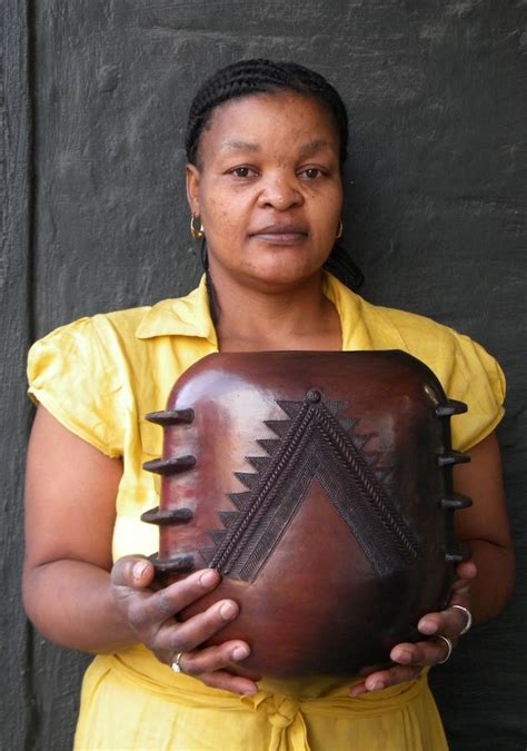 Africa | Jabu Nala holding one of her pots. Jabu is the eldest daugher of Nesta Nala and has for ...