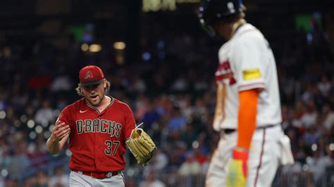 D-backs' Kevin Ginkel walks back Braves' Ronald Acuna Jr.