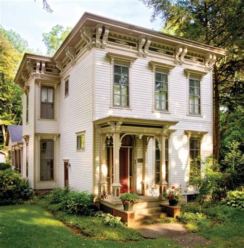 a large white house sitting on top of a lush green field