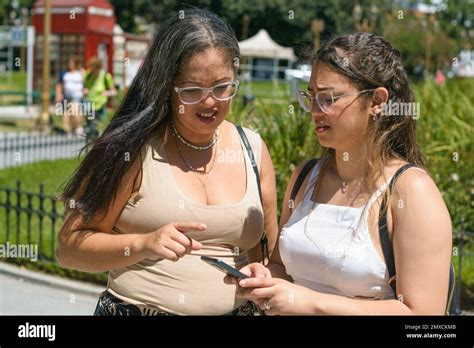 two young latin women tourists of venezuelan ethnicity, standing in a ...