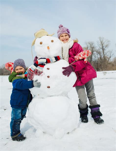 Kids make a snowman stock photo. Image of childhood, build - 33416514