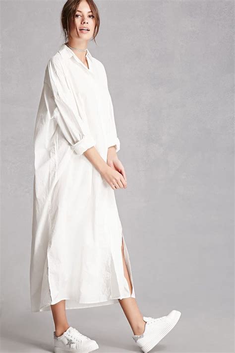 This longline cotton woven shirt dress features an oversized silhouette ...