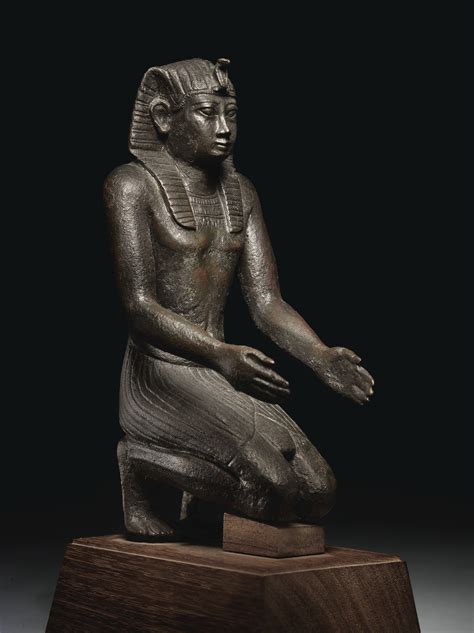 AN EGYPTIAN BRONZE FIGURE OF PHARAOH NECHO IILATE PERIOD, 26TH DYNASTY ...