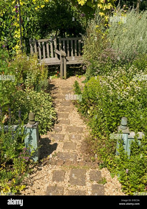 Small English cottage garden with paved and gravel path, borders and ...