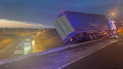 Lorry left hanging off bridge after M1 crash forces closure of major ...