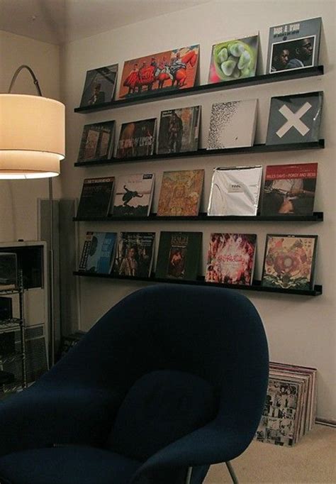 a blue chair sitting in front of a wall filled with books