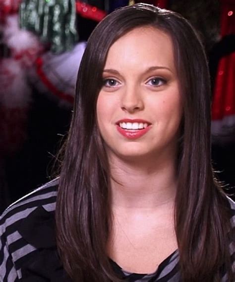 a woman with long brown hair wearing a black and white striped shirt is ...