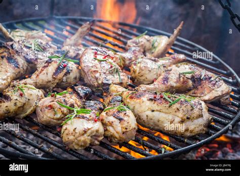 Spicy chicken on grill with spices and rosemary for grill Stock Photo ...