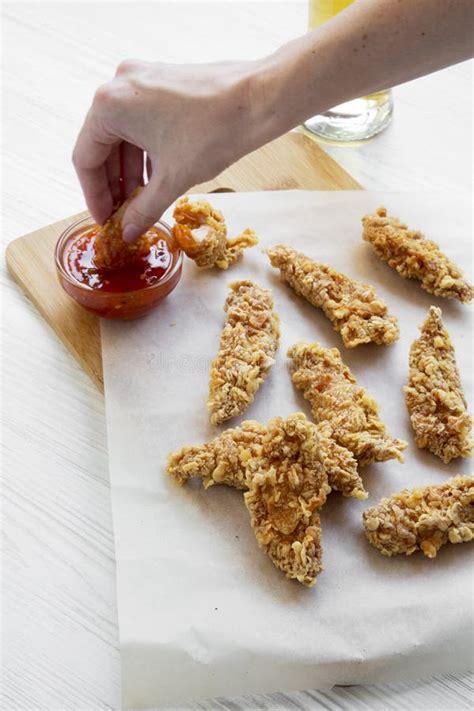 Female Hand Dipping Chicken Strips into Sauce Stock Photo - Image of ...