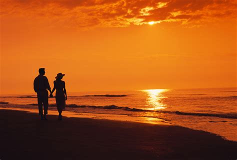 Two People Walking On The Beach In The Sunset - Viewing Gallery