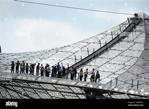 Stadium visitors on a tour on the tent roof of the Munich Olympic ...