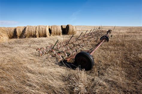 Machinery and Large Hay Bales. Stock Image - Image of blue, countryside: 110080917