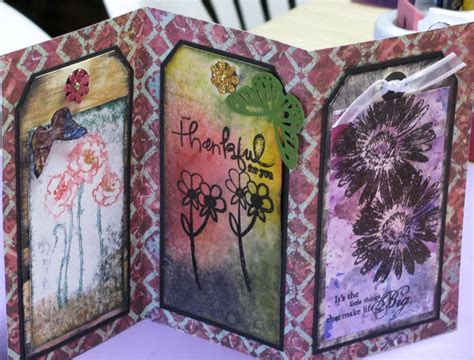 an open handmade card with flowers and words on the front, sitting on ...