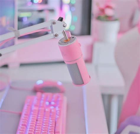 a pink computer keyboard sitting on top of a white desk