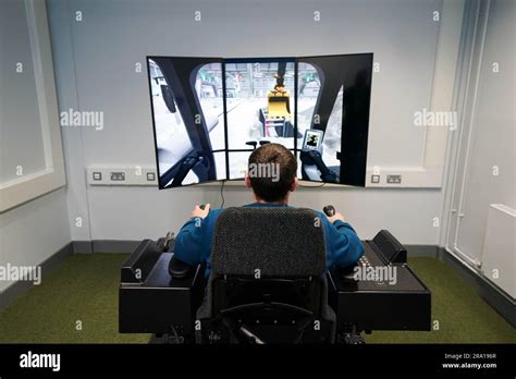 An inmate uses a construction simulator during the official opening of ...