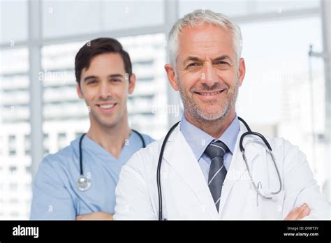 Two smiling doctors standing Stock Photo - Alamy