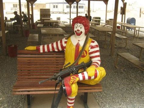 A statue of Ronald McDonald holding an M249 light machine-gun at a ...