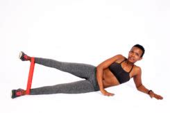 Fit Woman Doing Lying Side Leg Raises With Resistance Band