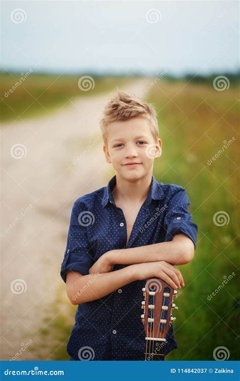 Handsome Cute Boy is Holding Acoustic Guitar in Outdoor Stock Image ...