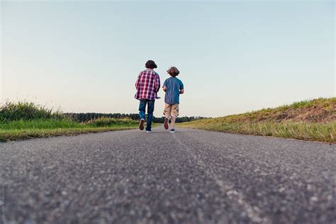 "Two Boys Walking Away On A Long Path In The Fields" by Stocksy Contributor "Cindy Prins" - Stocksy