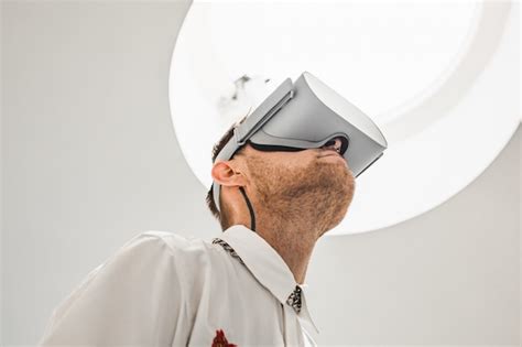 Free Photo | A low angle photo of a futuristic cool male doctor wearing VR goggles in a hospital