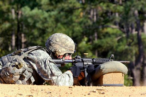 A soldier fires his M4 carbine rifle during a stress shoot range at the All-American Best Medic ...