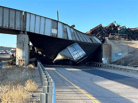 Truck driver killed when train derails, railroad bridge collapses in ...