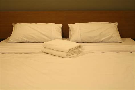 Hotel bed with white sheets 1901748 Stock Photo at Vecteezy