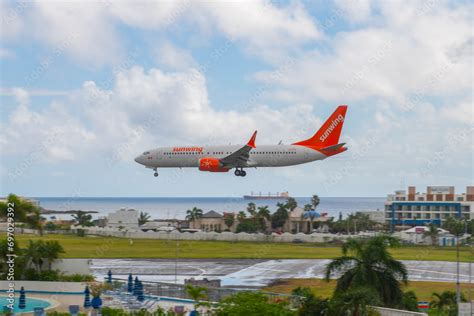 Sunwing Airlines Boeing 747 Max 8 flying over Maho Beach before landing on Princess Juliana ...