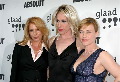 three women standing next to each other on a red carpet