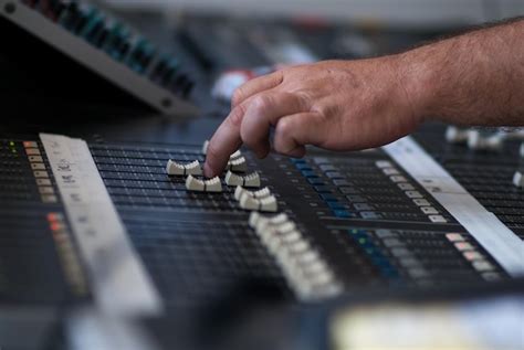 Premium Photo | Technician adjusting sound mixer at studio