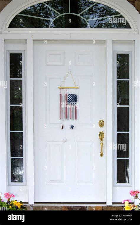 American flag wind chimes hanging on a white entry door Stock Photo - Alamy