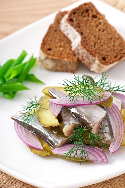 Free Photo | Herring salad with pickled cucumbers and onions