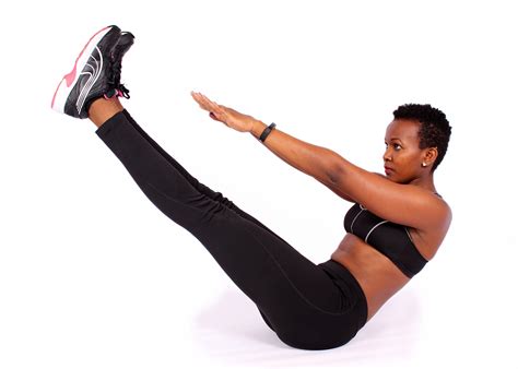 Fit african woman doing v ups ab exercise